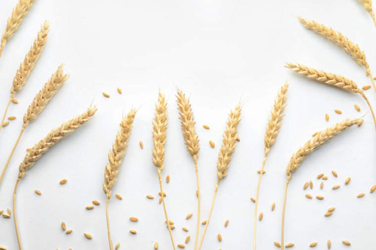 Wheat grains with spikelets on white background