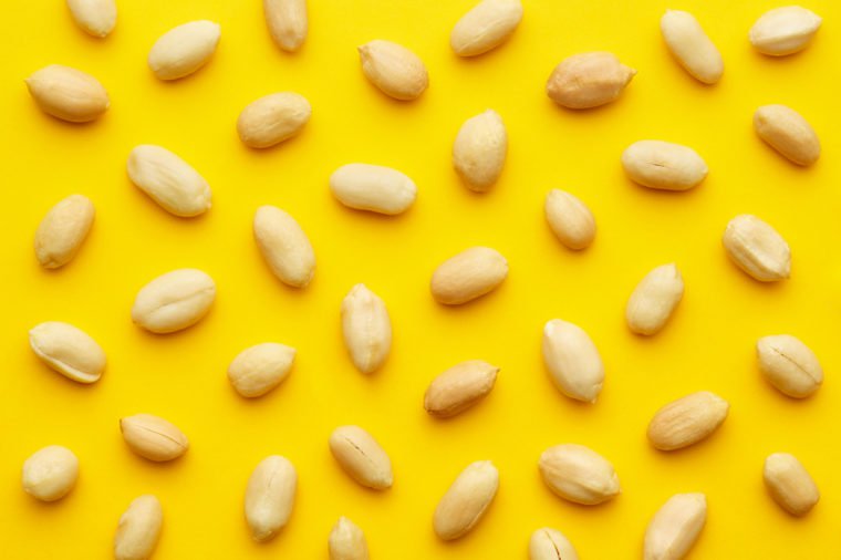 Peanuts pattern isolated on a yellow backround. Repetition concept. Top view
