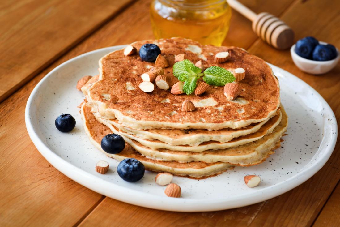 Gluten-free pancakes for different diets topped with blueberries and nuts