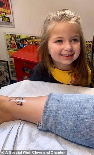She smiled as her panda design was etched on her mother's ankle