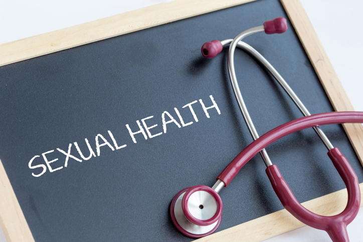 Sexual health written on blackboard with stethoscope placed on top