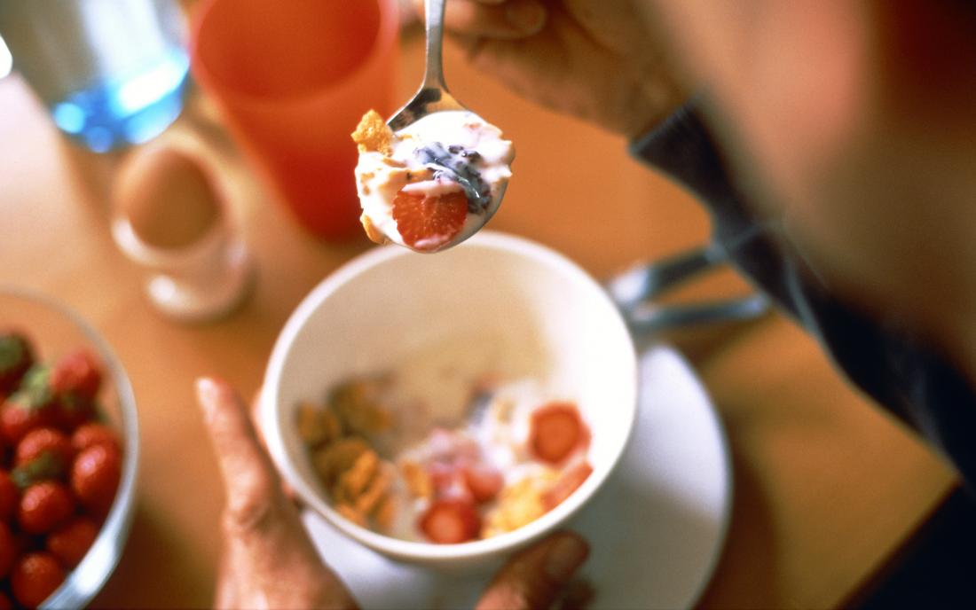 a person eating cereal as part of a diet to help their diverticulitis