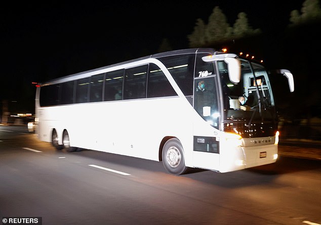 Some 1,500 people were evacuated from the ship on Monday, including two dozen people requiring urgent medical care. Pictured, a bus full of American passengers arrives at Travis Air Force Base in Fairfield, California