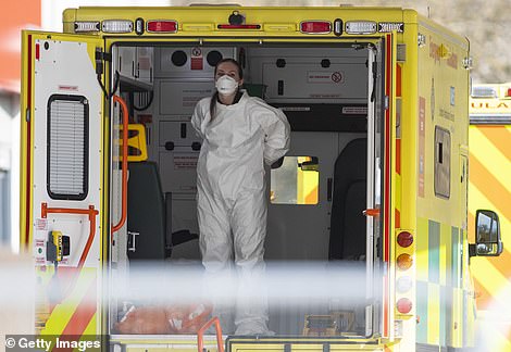 A medical worker is pictured in an ambulance outside St Thomas' Hospital in London, where Prime Minister Boris Johnson is being treated