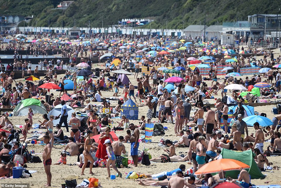 The packed beach in Bournemouth this afternoon. People in England are now allowed to travel for day trips but must stay at least six feet away from people who are not from their household, something that is difficult in such crowded areas