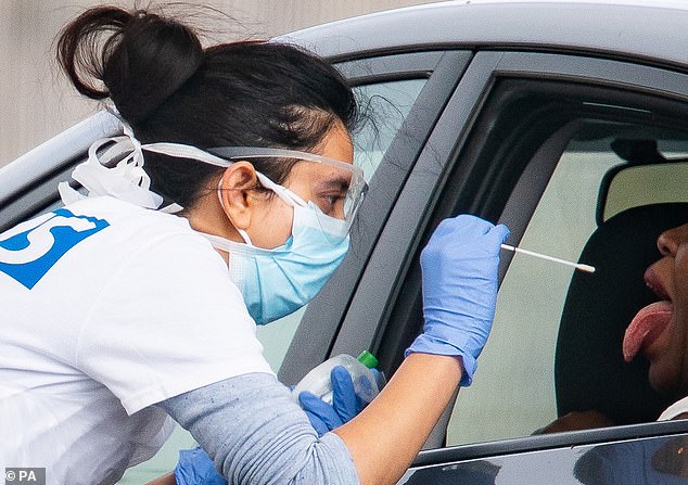 Throughout the crisis, medics in full hazmat suits have been photographed leaning through car windows and taking saliva samples from suspected patients at dozens of sites dotted around the country. Pictured: A drive-in testing facility at the Chessington World of Adventures Resort, west London