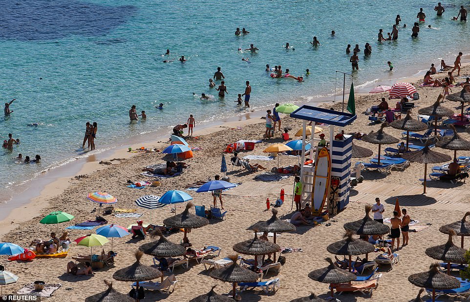 Holidaymakers return to Portals Nous in Mallorca yesterday as Spain starts to return to normal