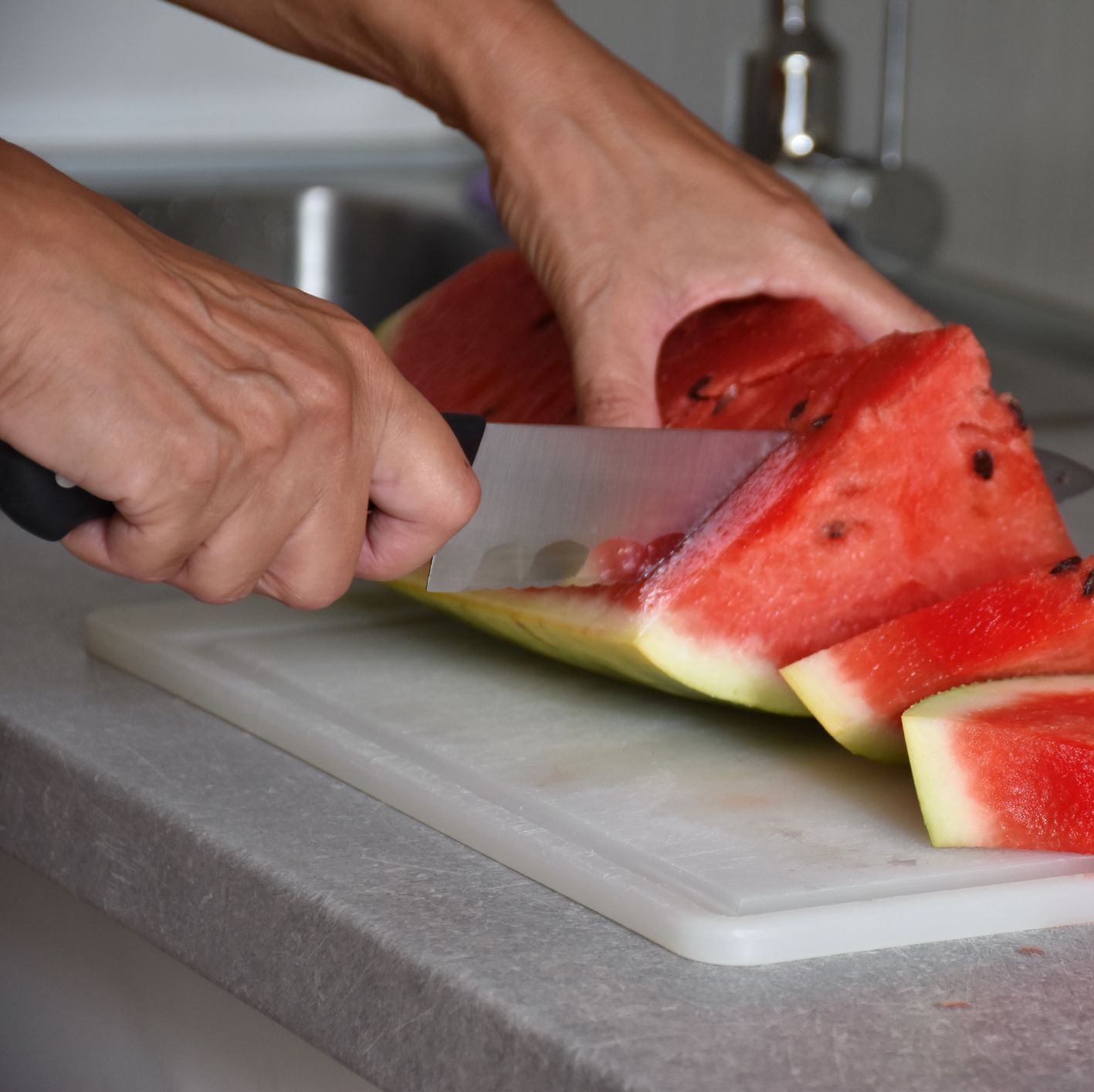 midsection of woman preparing food on cutting board