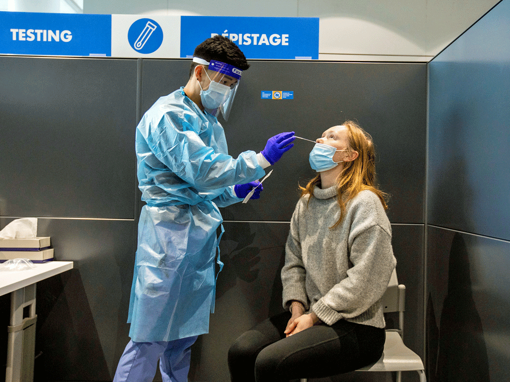 A passenger receives a COVID-19 test at Toronto's Pearson airport on February 1, 2021. The new antigen COVID test will be used starting March 1 in a federal research project at the airport.
