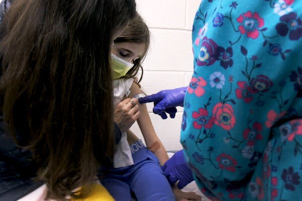A 9-year-old participant receiving the first shot in a clinical trial of Pfizer’s vaccine in children under 12, at Duke University in North Carolina.