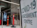A nurse guides people being tested for COVID-19 outside a hospital in Toronto December 10, 2020.